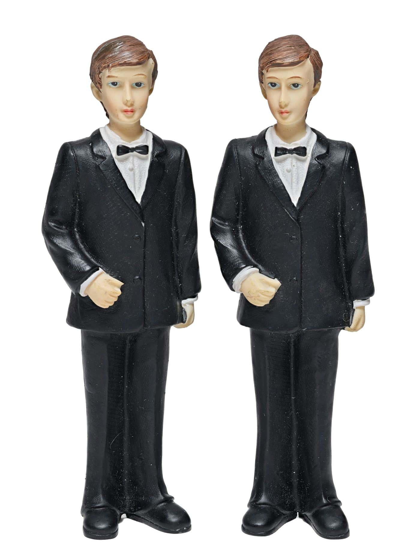 Two identical figurines in matching black suits and bow ties