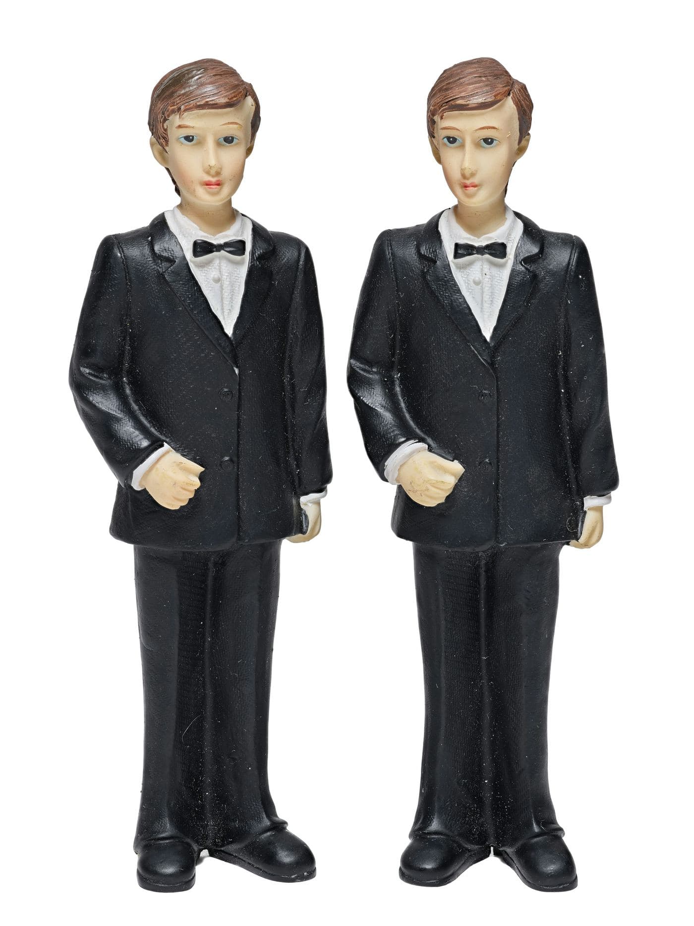 Two identical figurines in matching black suits and bow ties