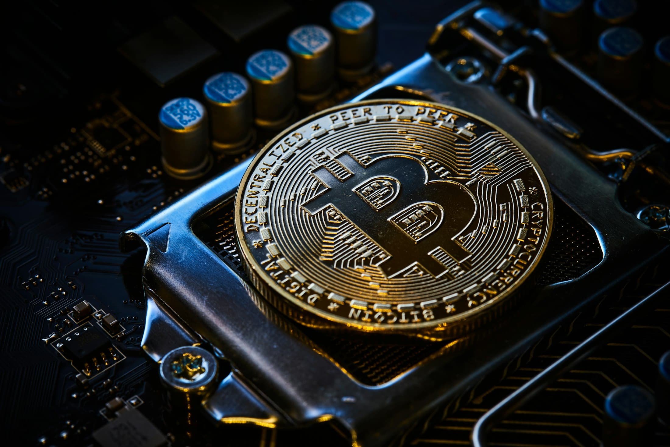 A bitcoin resting on a computer motherboard